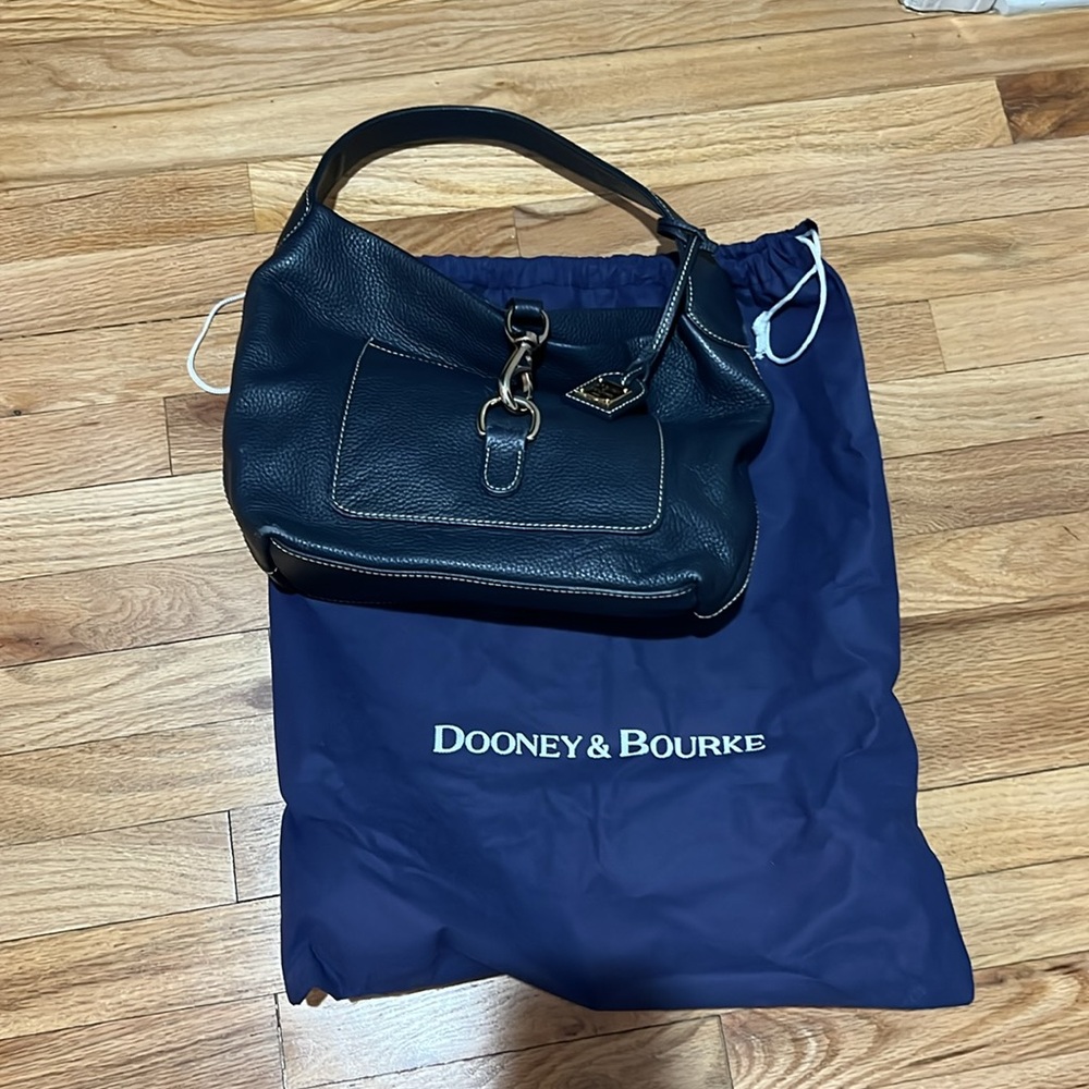 Dooney and Bourke, all weather, leather, navy satchel bag with clip over closure